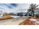 Charming home featuring a long driveway and classic curb appeal with hints of melting snow at 3282 W 66Th Ave, Denver, CO 80221