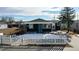 Exterior view of home with a cute picket fence, landscaped yard, and a vibrant blue front door at 3282 W 66Th Ave, Denver, CO 80221
