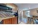 A modern kitchen featuring stainless steel appliances, stylish backsplash and adjacent dining area at 3282 W 66Th Ave, Denver, CO 80221