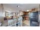 Open kitchen with stainless steel appliances and wood cabinets at 3282 W 66Th Ave, Denver, CO 80221