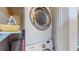 Convenient laundry area with stacked washer and dryer units and storage shelves at 3282 W 66Th Ave, Denver, CO 80221