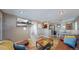 Inviting living room featuring an entertainment center, a cozy sofa, and an open layout to the dining area at 3282 W 66Th Ave, Denver, CO 80221