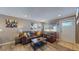 Inviting living room with wood floors, brown sofa, natural light, and cozy decor at 3282 W 66Th Ave, Denver, CO 80221