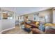 Inviting living room featuring a cozy leather sofa, stylish decor, and an open layout to the dining area at 3282 W 66Th Ave, Denver, CO 80221