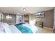 Spacious main bedroom with a plush bed, modern entertainment center, and access to an outdoor patio at 3282 W 66Th Ave, Denver, CO 80221