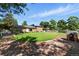 A sprawling backyard offers a lush lawn, mature trees, and a playful playhouse, perfect for enjoying the outdoors at 1380 Holly E Dr, Broomfield, CO 80020
