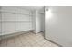 Finished basement with tile floors, white walls and shelves leading to a large closet at 1380 Holly E Dr, Broomfield, CO 80020