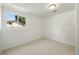 Finished basement room features neutral carpet, a window, and white painted walls and ceiling at 1380 Holly E Dr, Broomfield, CO 80020
