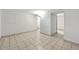 Large finished basement with tile flooring and white walls leading to stairs and closet at 1380 Holly E Dr, Broomfield, CO 80020