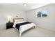 Bright bedroom with modern decor and a view of mature trees from the bright window at 1380 Holly E Dr, Broomfield, CO 80020