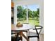 Bright dining area with glass doors to back yard and view of green backyard at 1380 Holly E Dr, Broomfield, CO 80020