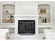 Charming brick fireplace with built-in shelving, perfect for displaying decor and books at 1380 Holly E Dr, Broomfield, CO 80020