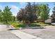 Beautiful home exterior with a lush green lawn and mature trees along a peaceful residential street at 1380 Holly E Dr, Broomfield, CO 80020