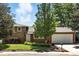 Charming home exterior featuring a well-manicured lawn and mature trees in a serene neighborhood at 1380 Holly E Dr, Broomfield, CO 80020