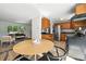 Bright eat-in kitchen features wood cabinets, stainless appliances, and a view to the living room at 1380 Holly E Dr, Broomfield, CO 80020