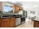 Well-lit kitchen features modern stainless steel appliances, granite counters, and views of the backyard at 1380 Holly E Dr, Broomfield, CO 80020