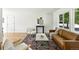 Cozy living room filled with natural light, a plush couch, and two accent chairs at 1380 Holly E Dr, Broomfield, CO 80020