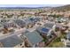 A neighborhood featuring houses with solar panels and manicured lawns at 3502 First Light Dr, Castle Rock, CO 80109