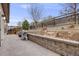 Beautiful backyard featuring a stone patio, retaining wall, and professional landscaping at 3502 First Light Dr, Castle Rock, CO 80109