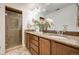 Bathroom featuring double sinks, granite countertops, and a glass enclosed shower at 3502 First Light Dr, Castle Rock, CO 80109