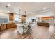 Open concept kitchen, wood cabinets, stainless appliances, large center island for gathering. Flow to living room at 3502 First Light Dr, Castle Rock, CO 80109