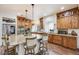 Modern kitchen boasts granite countertops, stainless appliances, wood cabinetry, and a large island with barstool seating at 3502 First Light Dr, Castle Rock, CO 80109