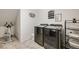 Efficient laundry room featuring modern machines, storage shelving, and laundry themed decor at 3502 First Light Dr, Castle Rock, CO 80109