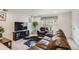 Cozy living room with plush leather seating, carpet flooring, and TV at 3502 First Light Dr, Castle Rock, CO 80109