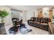 Comfortable living room with leather furniture, carpet flooring, and natural light at 3502 First Light Dr, Castle Rock, CO 80109