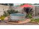 Backyard featuring a stock tank pool surrounded by pea gravel and landscaping at 3650 Chimayo Rd, Littleton, CO 80123