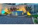 Backyard featuring a stock tank pool with gravel landscaping and ambient lighting at 3650 Chimayo Rd, Littleton, CO 80123