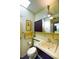 A stylish bathroom featuring yellow tile, sleek fixtures, and a modern design at 3650 Chimayo Rd, Littleton, CO 80123