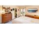 Cozy mid-century bedroom with ample natural light and storage, plus ensuite bathroom at 3650 Chimayo Rd, Littleton, CO 80123