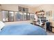Bedroom with bright light features desk area with shelves and three large windows at 3650 Chimayo Rd, Littleton, CO 80123