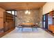 The dining room features a wood ceiling, stone wall, and built-in shelving at 3650 Chimayo Rd, Littleton, CO 80123
