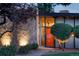 Mid-century modern home featuring a stone facade and an orange front door at 3650 Chimayo Rd, Littleton, CO 80123