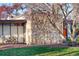 Stylish home exterior features a unique stone accent wall and well-maintained lawn at 3650 Chimayo Rd, Littleton, CO 80123