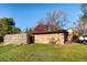 Sprawling single story home with stone facade, xeriscaping, and mature trees at 3650 Chimayo Rd, Littleton, CO 80123