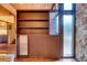 Hallway features built-in shelving and cabinets with glass display features at 3650 Chimayo Rd, Littleton, CO 80123