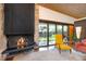 Bright living room featuring a fireplace, large windows, and a view of the outdoor landscape at 3650 Chimayo Rd, Littleton, CO 80123