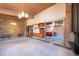 The living room boasts a unique stone wall, built-in shelving, and large sliding glass doors at 3650 Chimayo Rd, Littleton, CO 80123