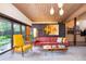 Well lit living room showcasing contemporary furnishings and a view to the outdoors at 3650 Chimayo Rd, Littleton, CO 80123