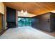 Spacious living room features a stone fireplace, wood ceiling and sliding doors to the outside at 3650 Chimayo Rd, Littleton, CO 80123