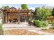 Inviting backyard featuring a stone patio, comfortable seating, a grill, and lush landscaping at 1185 Glencoe St, Denver, CO 80220