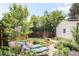 Serene backyard with lounge chairs, lush gardens, and a charming walking path at 1185 Glencoe St, Denver, CO 80220