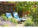 Relaxing backyard with lounge chairs nestled among lush greenery and vibrant flowers at 1185 Glencoe St, Denver, CO 80220