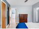 Bedroom featuring a modern color scheme, hardwood floors, and a wooden dresser at 1185 Glencoe St, Denver, CO 80220