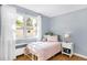 Cozy bedroom with sunlight streaming through the window and hardwood floors at 1185 Glencoe St, Denver, CO 80220
