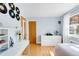 Bright bedroom with hardwood floors, large window, and a decorative record display at 1185 Glencoe St, Denver, CO 80220