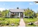 Charming single-story home with manicured front yard landscaping and a stone walkway leading to the front door at 1185 Glencoe St, Denver, CO 80220